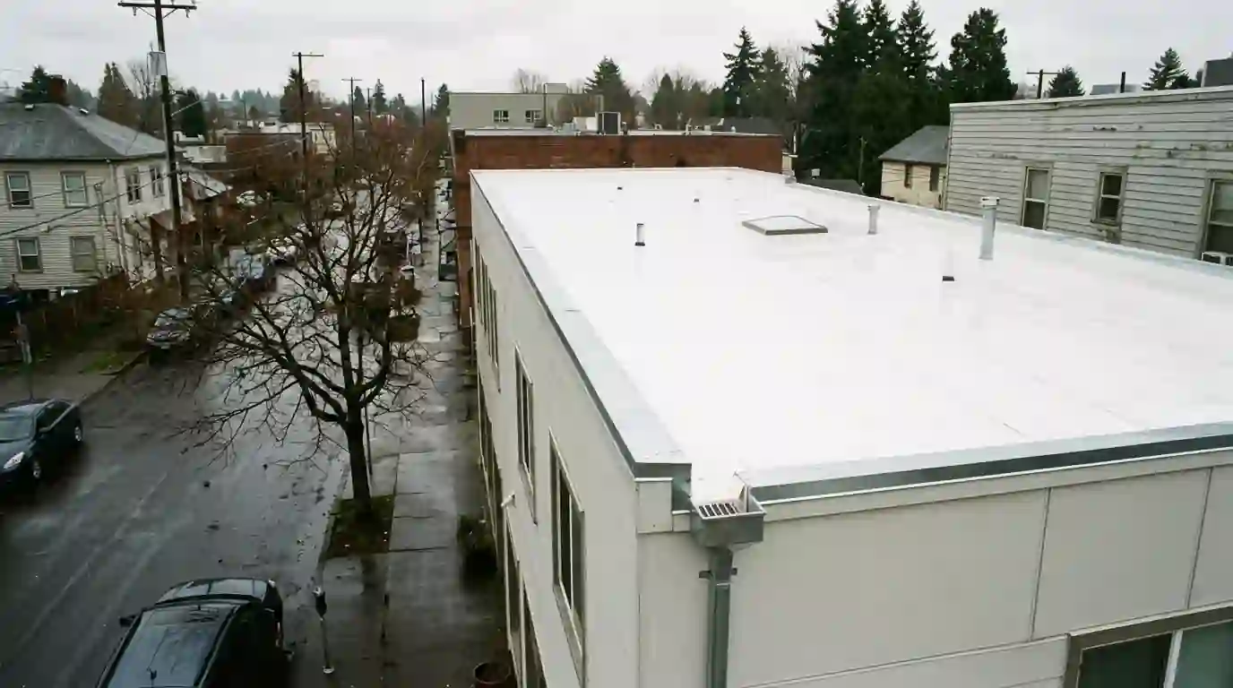 New white membrane flat roof with tapered insulation on a Portland building